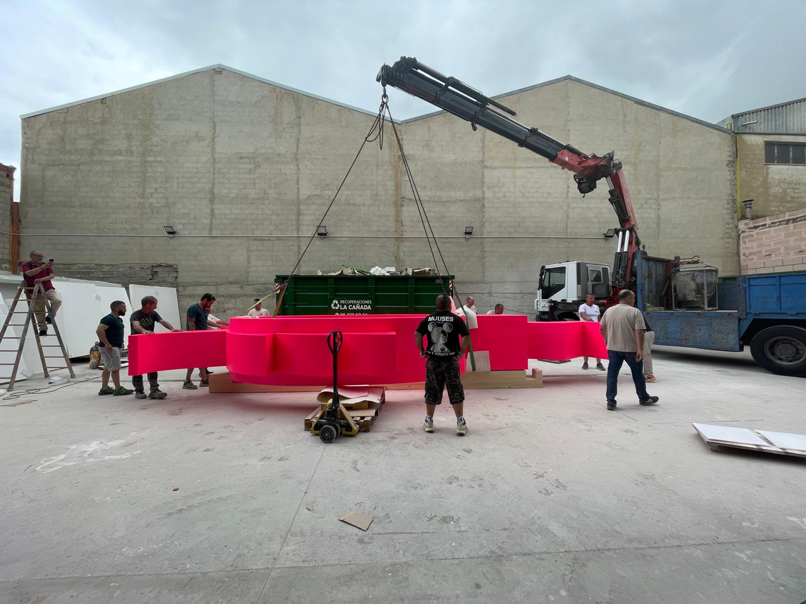Wide base ring laid out on the yard, crew rigging chains for the lift