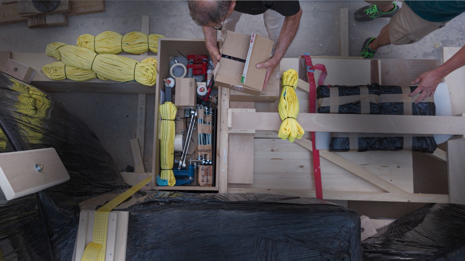 Overhead view of rigging, straps and tools packed into the crate