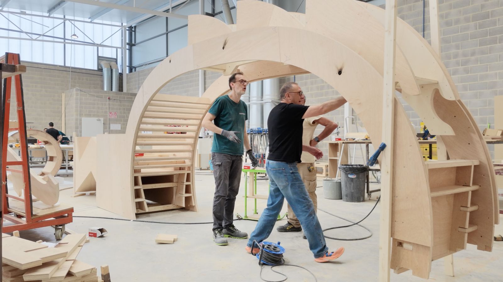 Fabricators assembling the plywood arch structure