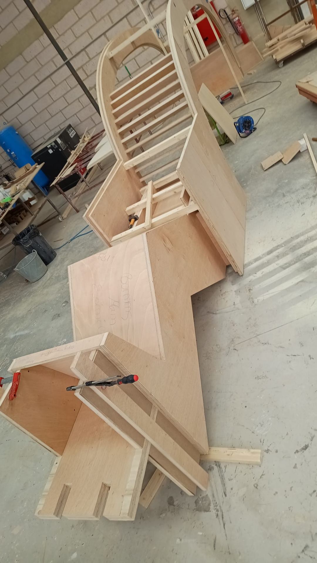 Plywood ribs and curved arch panels in the workshop